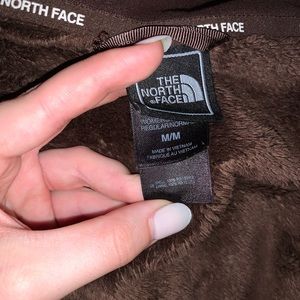 A brown fleece north face jacket